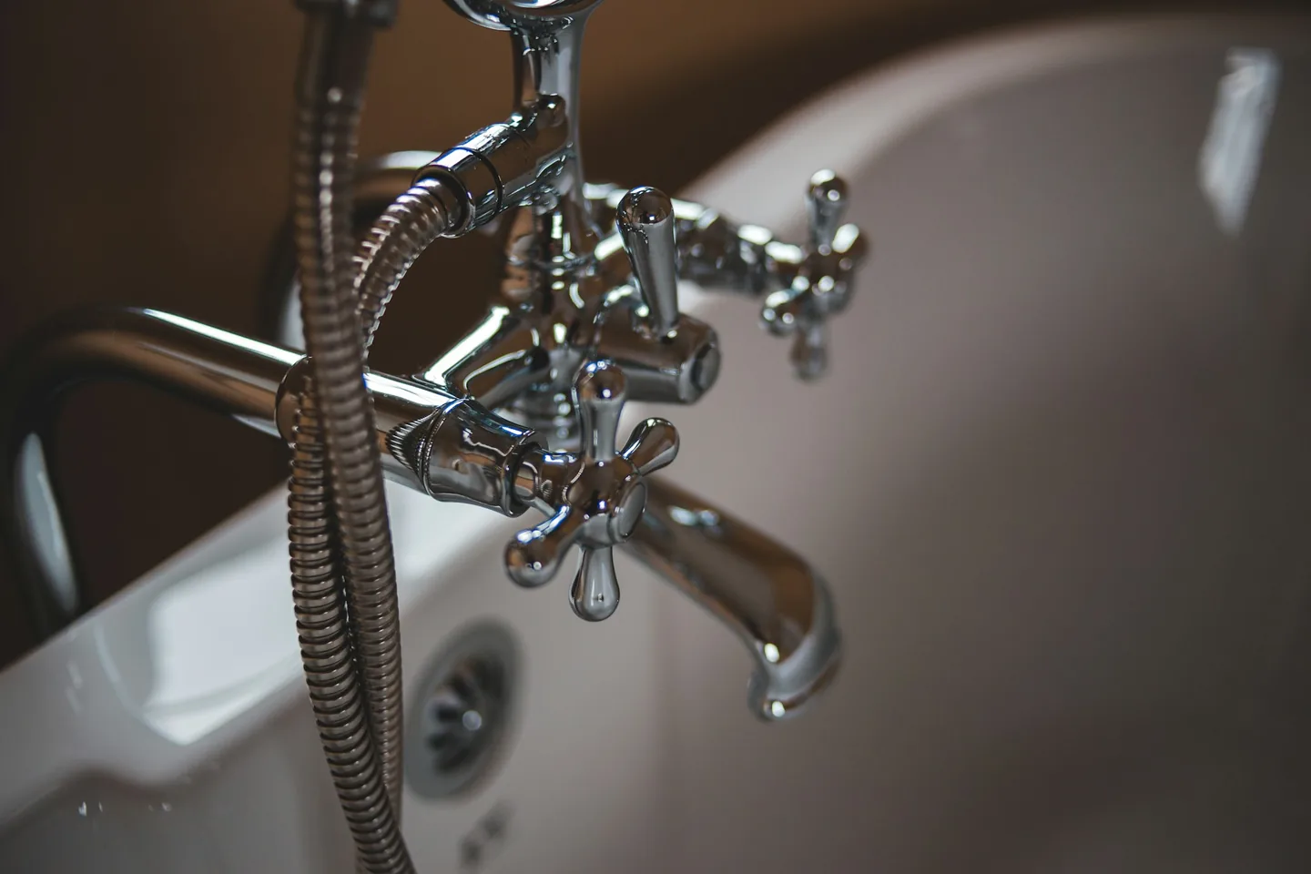 Water spraying from a burst pipe being repaired in a Dallas–Fort Worth home