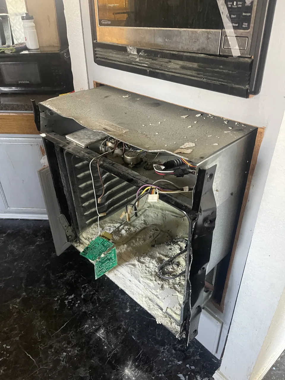 Kitchen appliance cavity opened for access and repair work