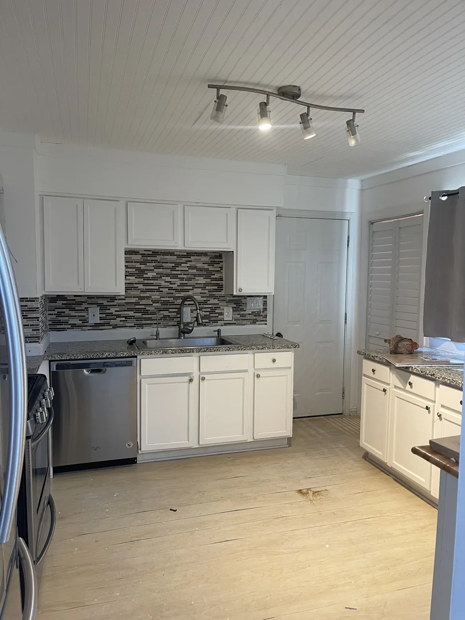 Kitchen cabinetry, flooring, and finishes documented during reconstruction work
