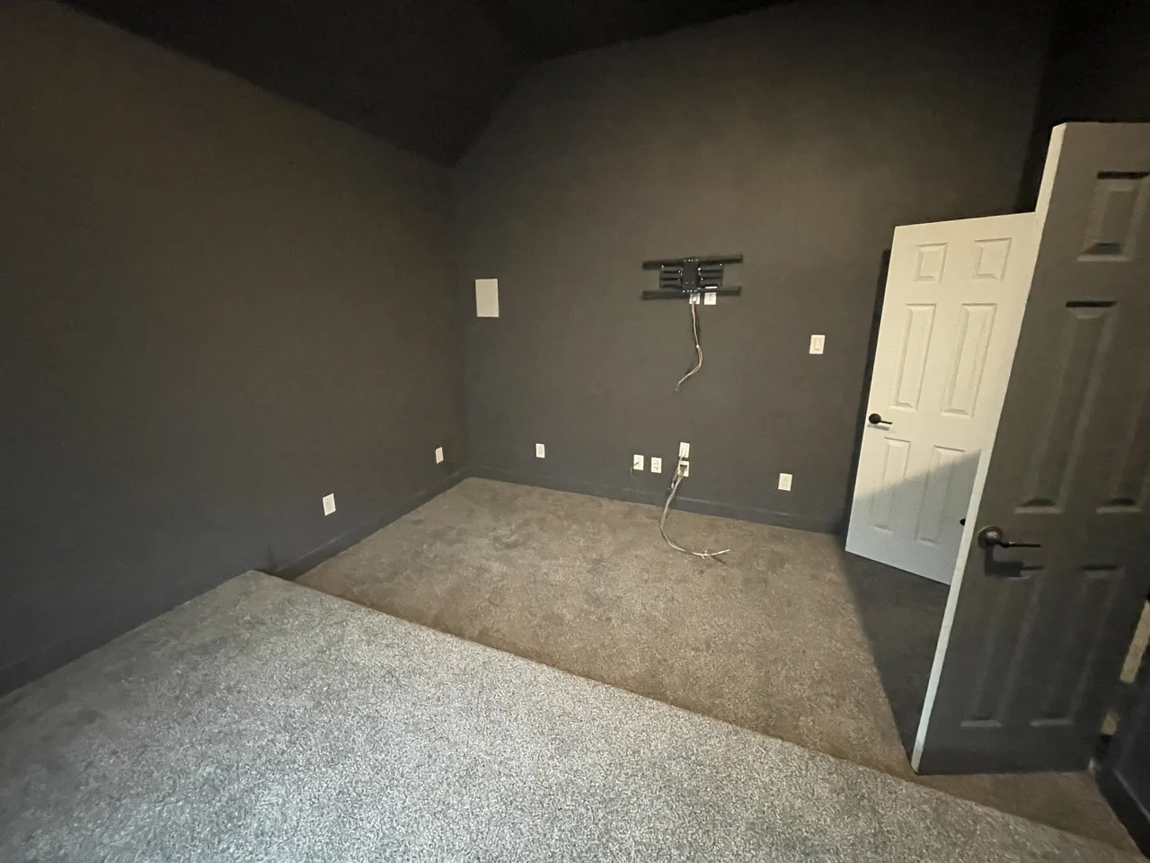 Residential room with carpet and wall finishes documented before additional flooring work